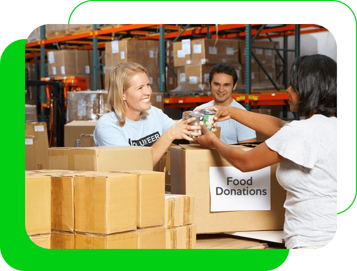 A group of people in a warehouse with boxes.