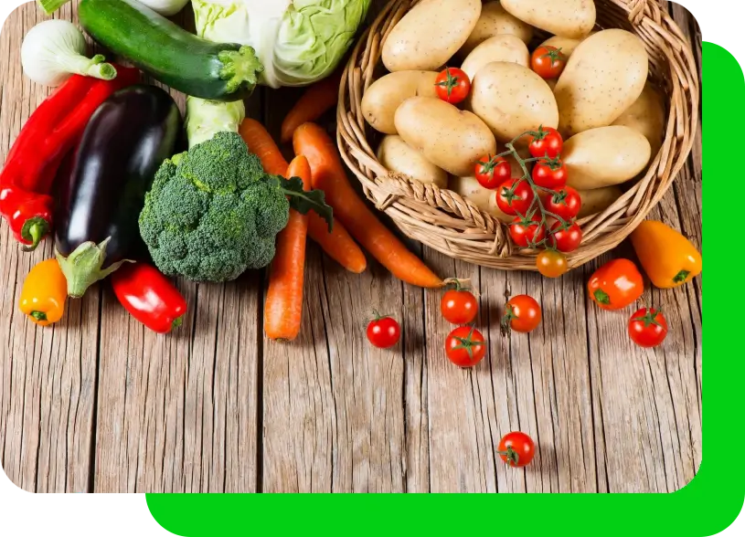 A wooden table topped with lots of vegetables.